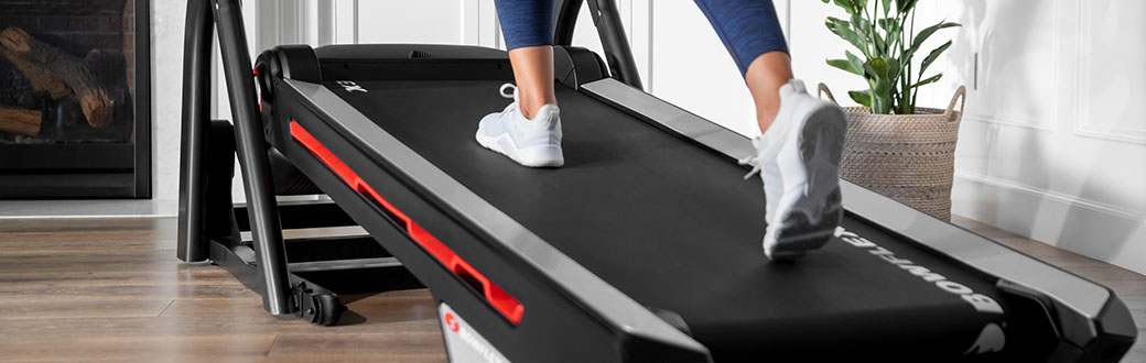 A person walking on a Bowflex treadmill.