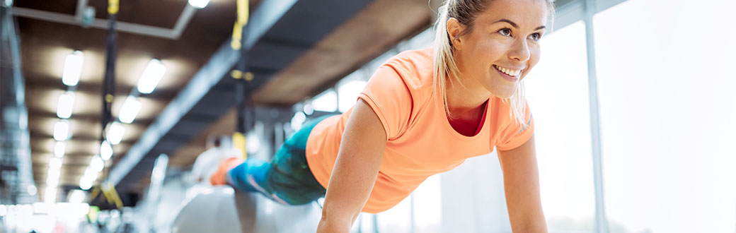 A woman performing an exercise ball jackknife.