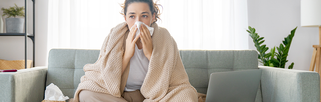 A woman blowing her nose