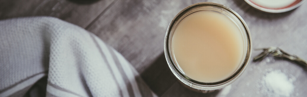 A jar of bone broth on a table.