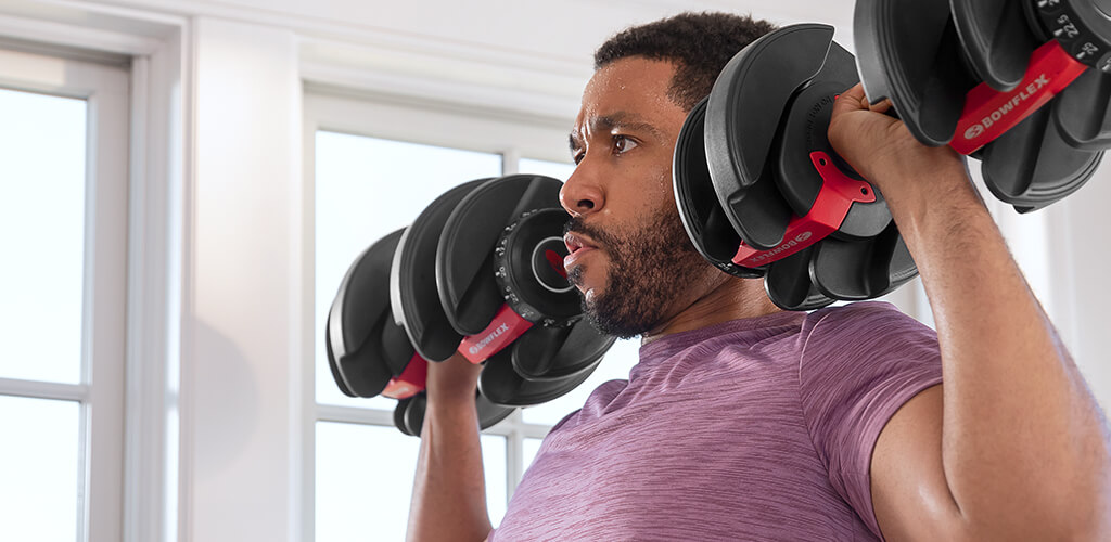 A man using 552 adjustable dumbbells.