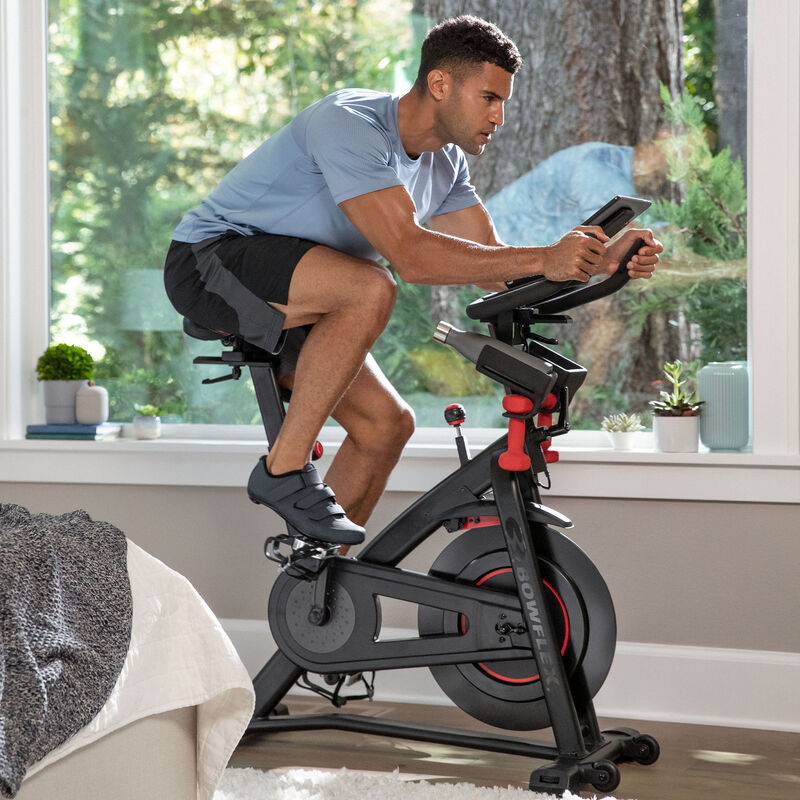 Man riding a stationary Bowflex C6 exercise bike - expanded view