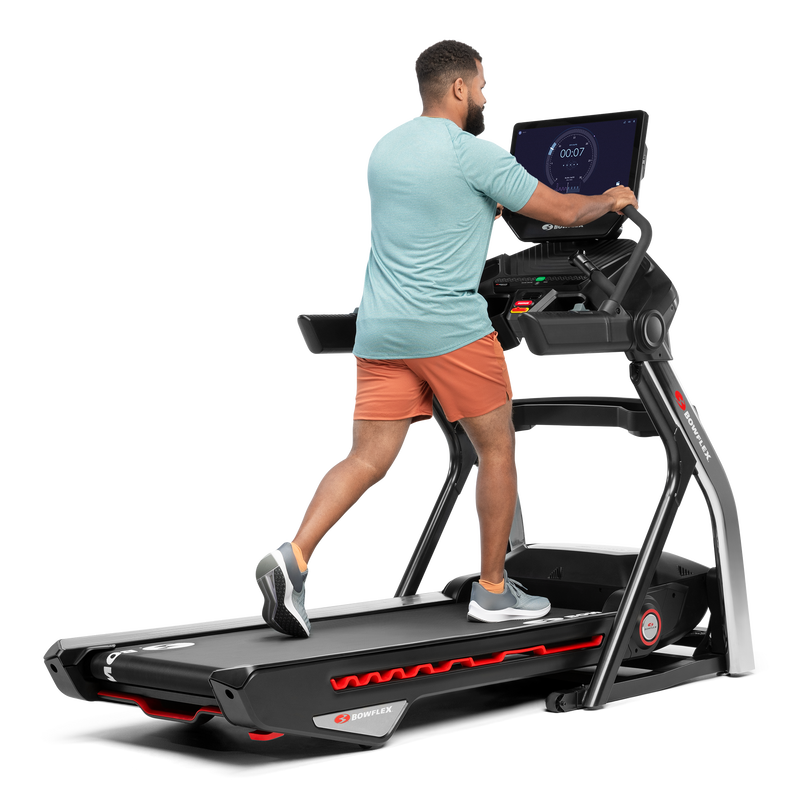 Man using the extended handlebars on the Treadmill 22 - expanded view