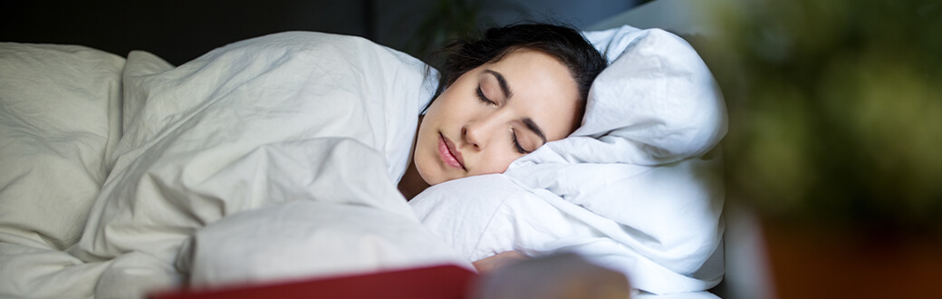 A woman sleeping in her bed.