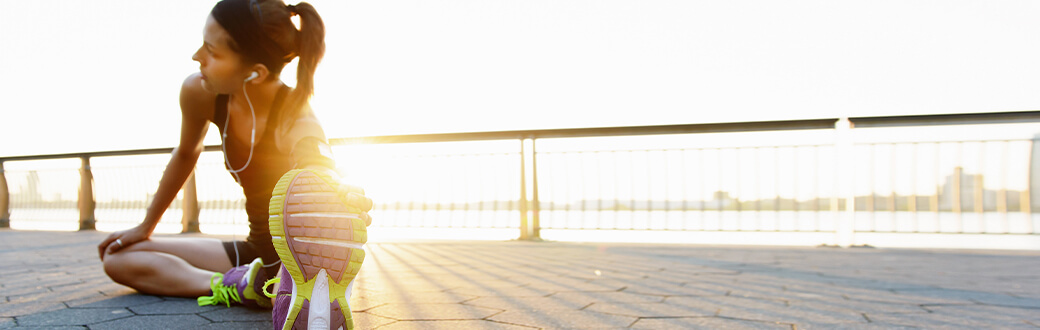 A woman stretching outside.