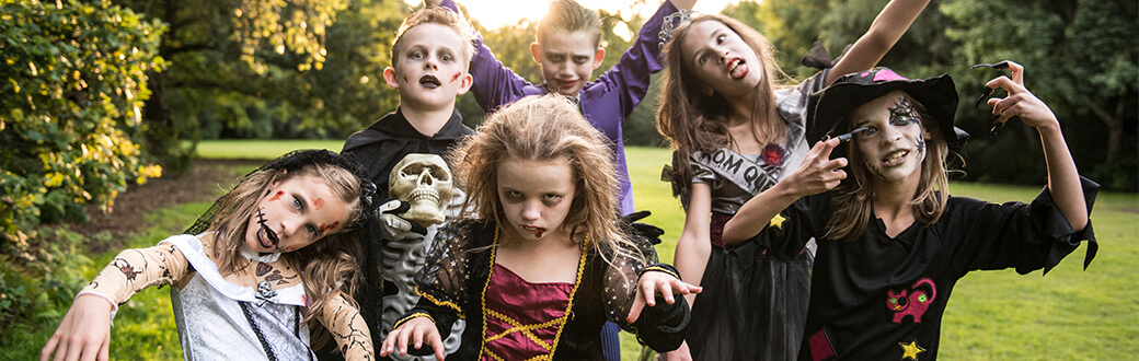 Several kids dressed in scary Halloween costumes.