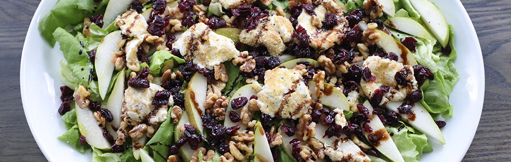 goat cheese medallions atop pear, cranberries, walnuts and lettuce