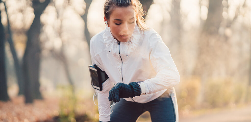 A woman exhaling while working out outside.