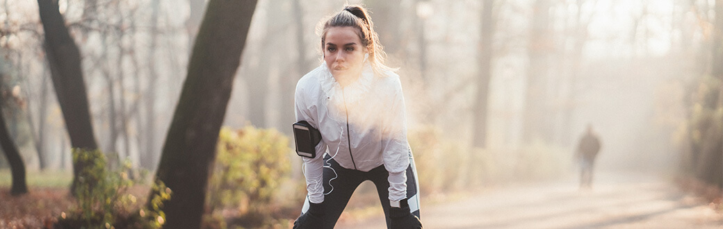 A woman exercising outside.