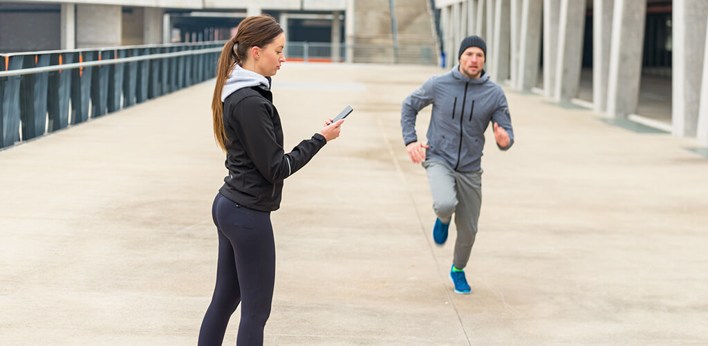 A person timing another runner.