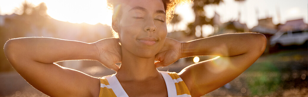 A woman stretching outside.