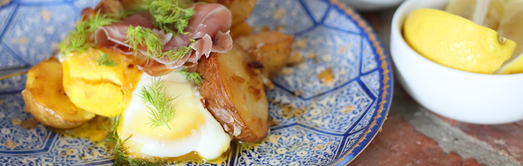 Cooked potatoes and eggs on a plate.