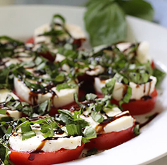 Caprese salad on a white plate.