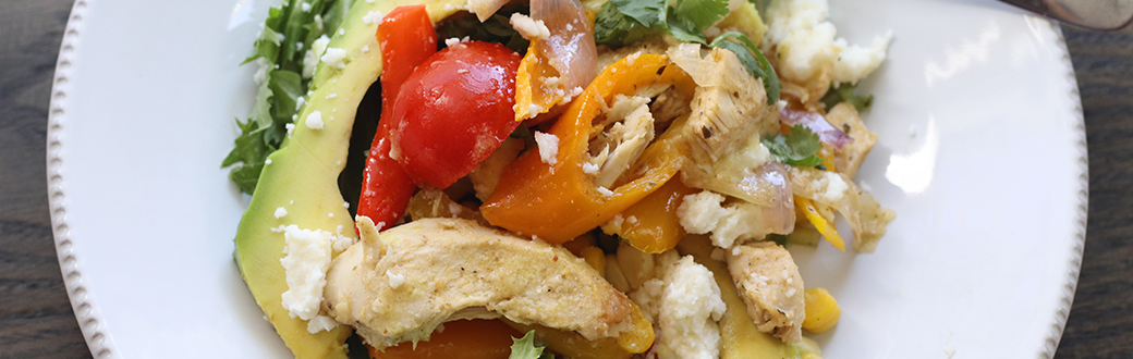 Chicken fajita salad on a plate.