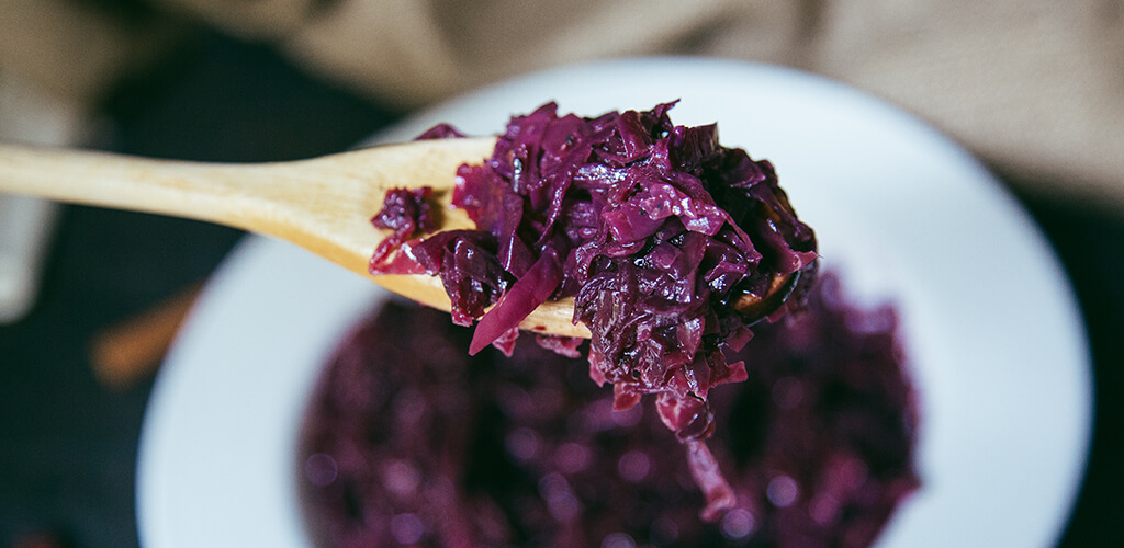 Braised cranberry and cabbage on a white plate.