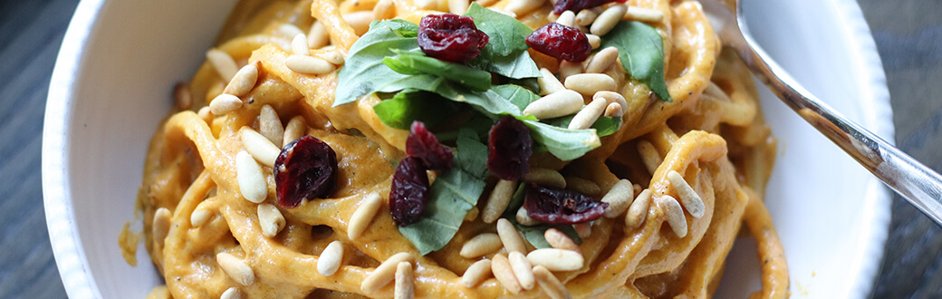 A bowl of creamy pumpkin pasta