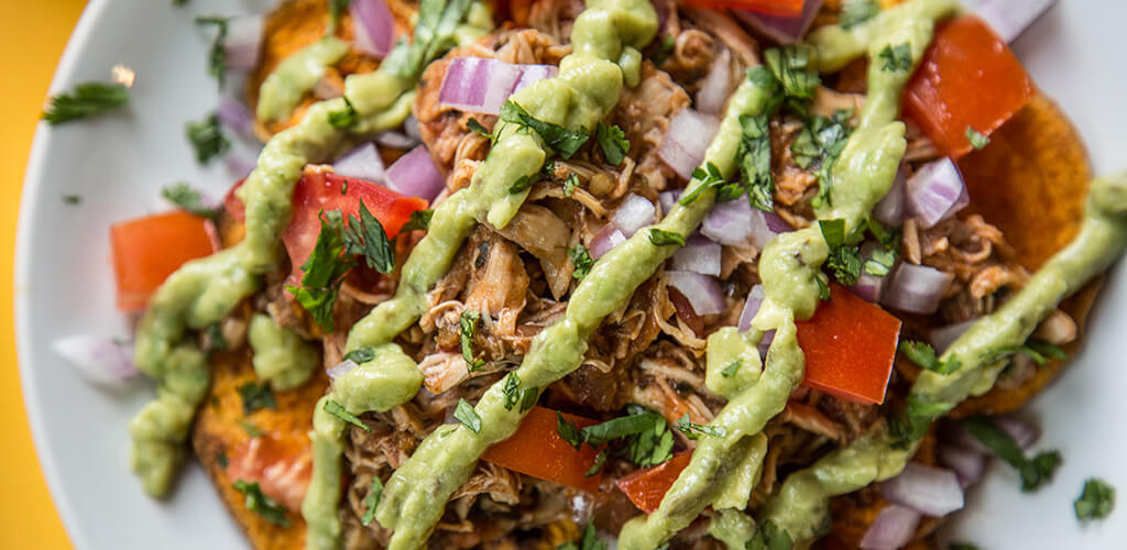 A plate of loaded sweet potato nachos