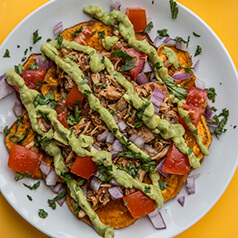 A plate of loaded sweet potato nachos