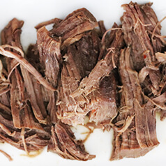 Shredded beef on a plate.