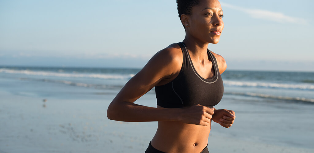 A woman running on the beach.