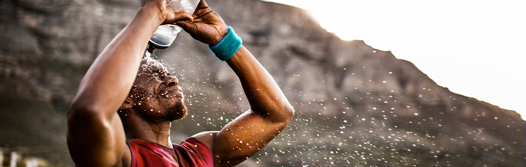 A man pouring water on his head.