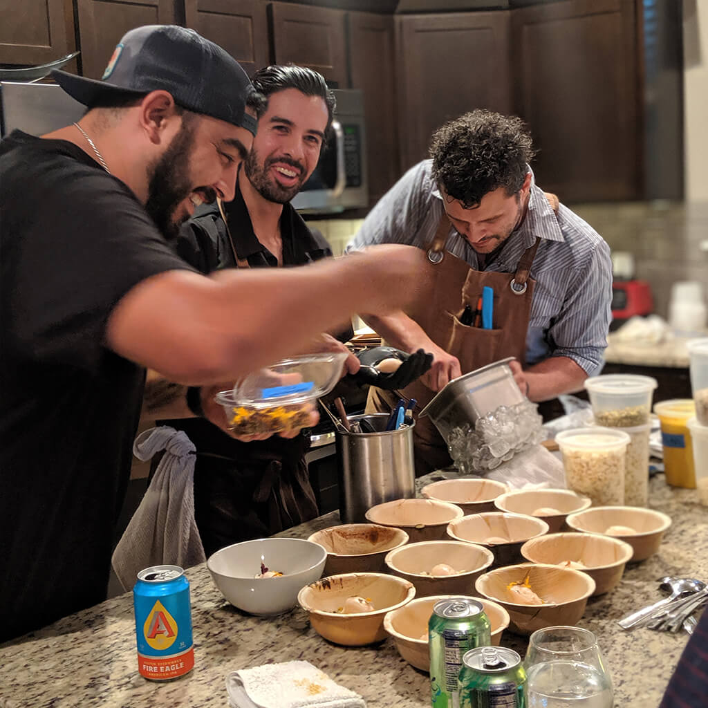 Three people making tostadas