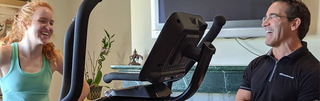 A woman using a Bowflex Max Trainer Max Total.