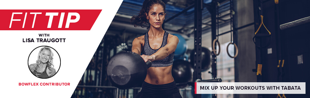 A fit woman in a gym swinging a kettelbell.