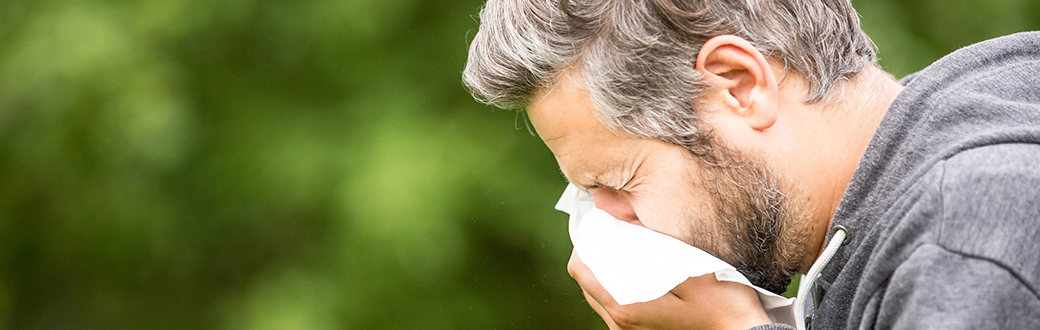 A man blowing his nose.